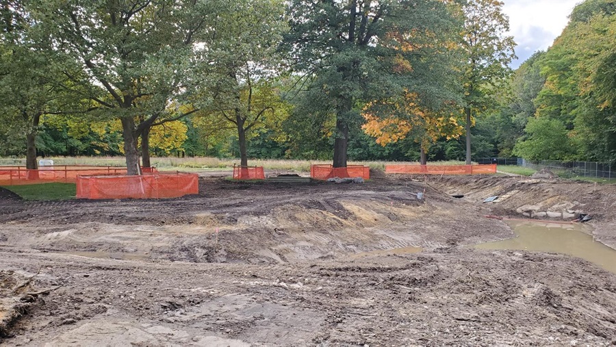 Dirt construction site surrounded by fence