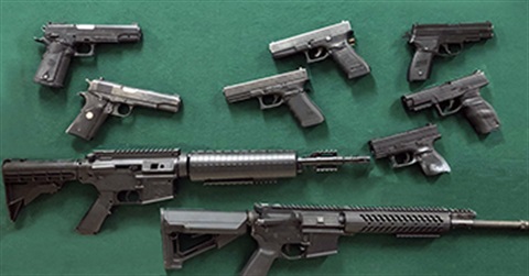 A board displaying real and replica guns
