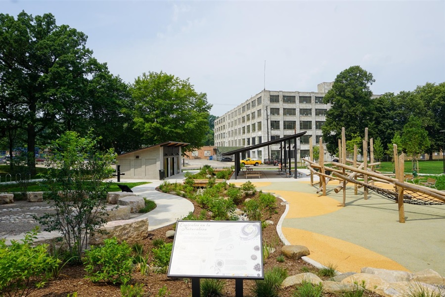 Wide shot of the playground, outdoor classroom, picnic shelter, and restroom