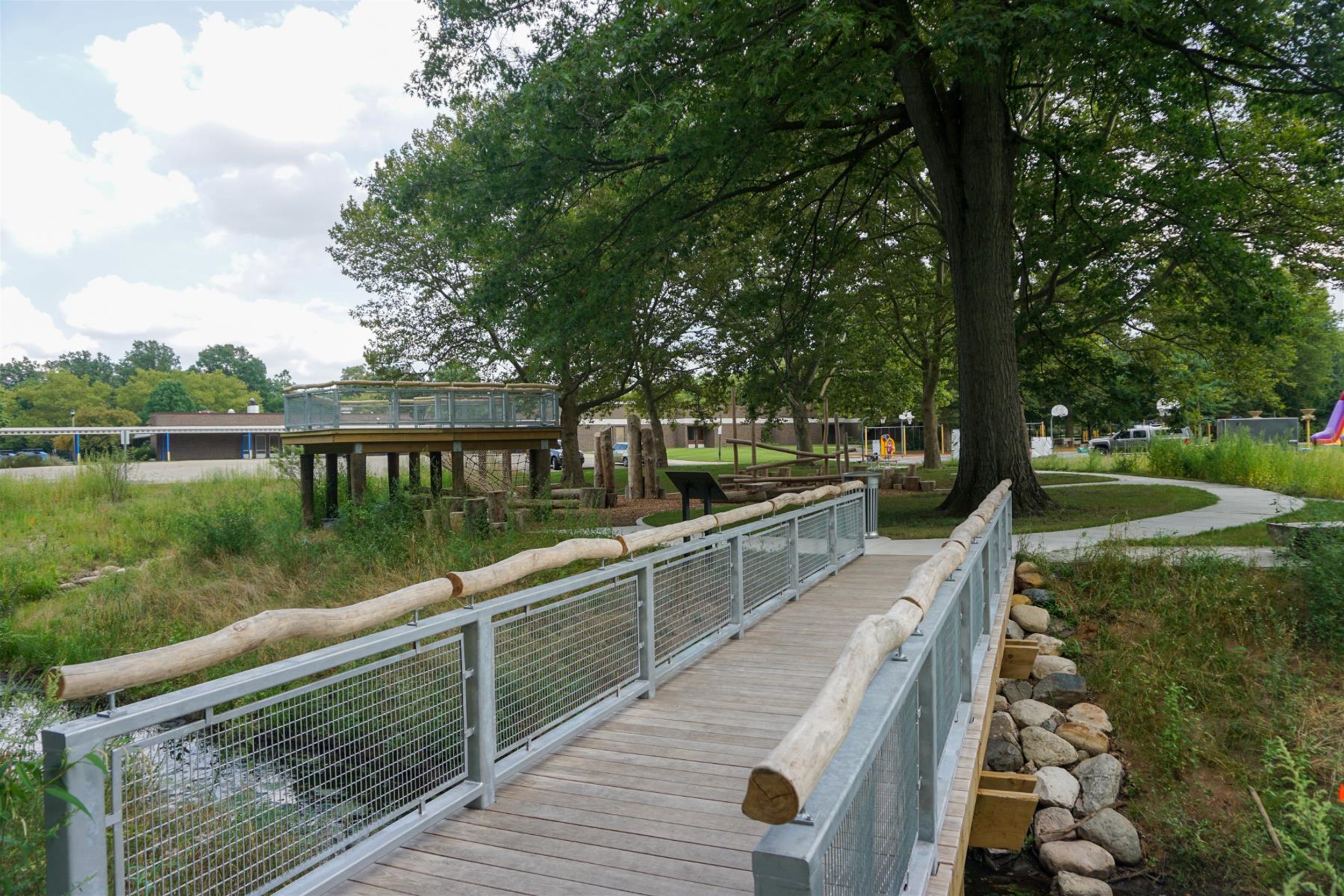Bridge over a daylighted stormwater management area