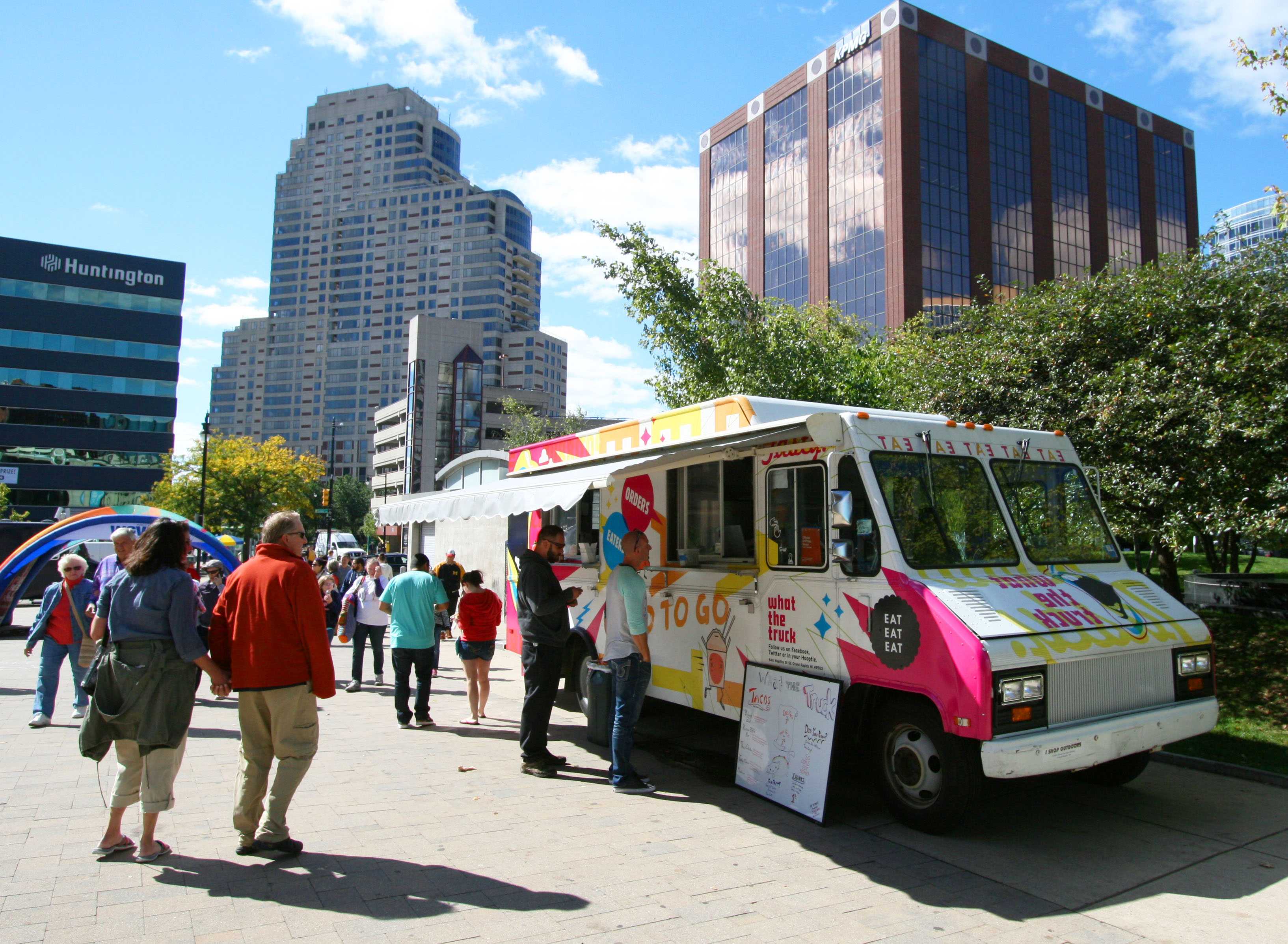 people standing in line or gazing the menu for an Art prize food truck downtown