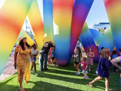 People playing under art installation