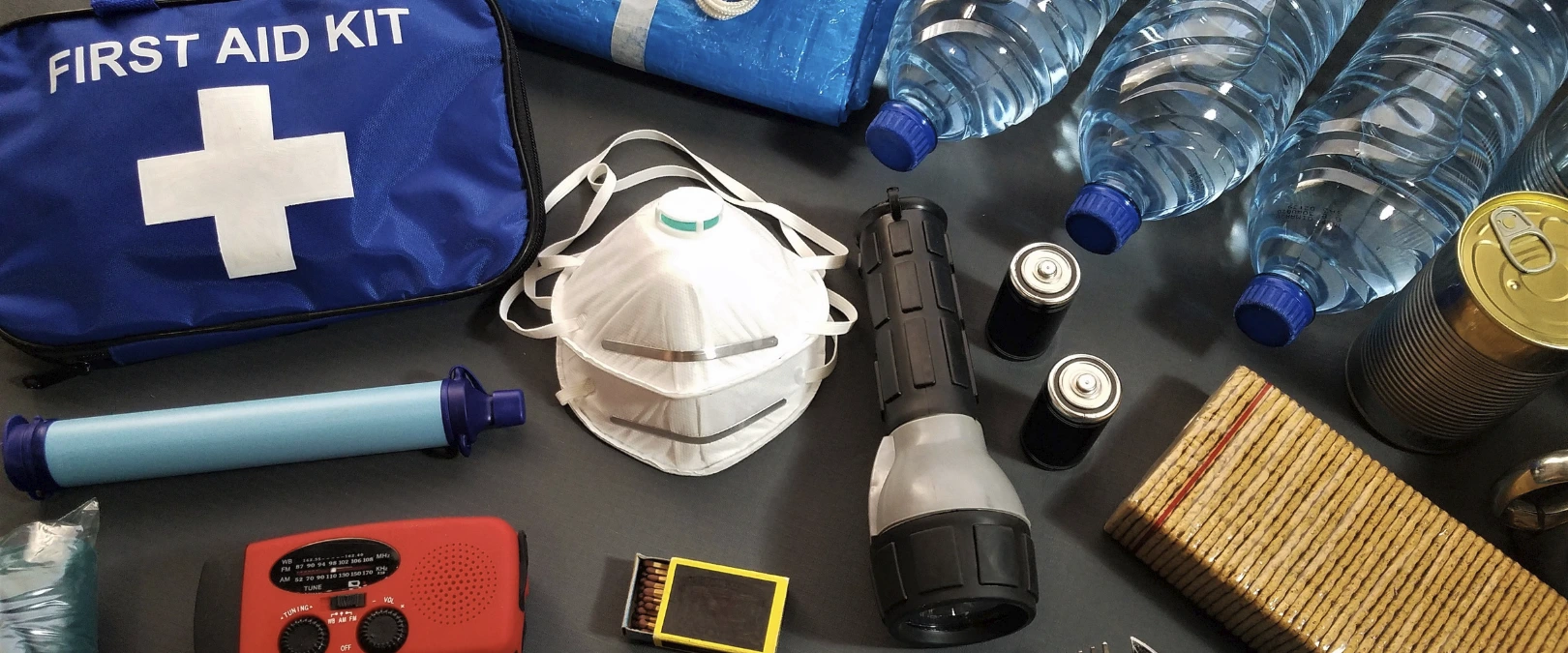 photo of emergency kit supplies like mask, flashlight, first aid kit, etc.