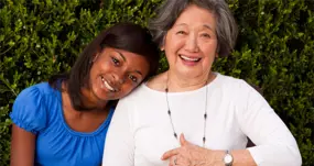 person resting head on another person's shoulder